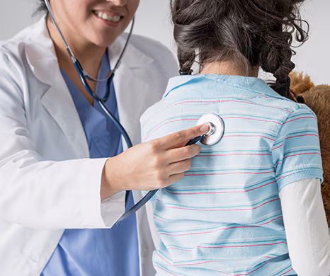doctor with stethoscope examining young female patient