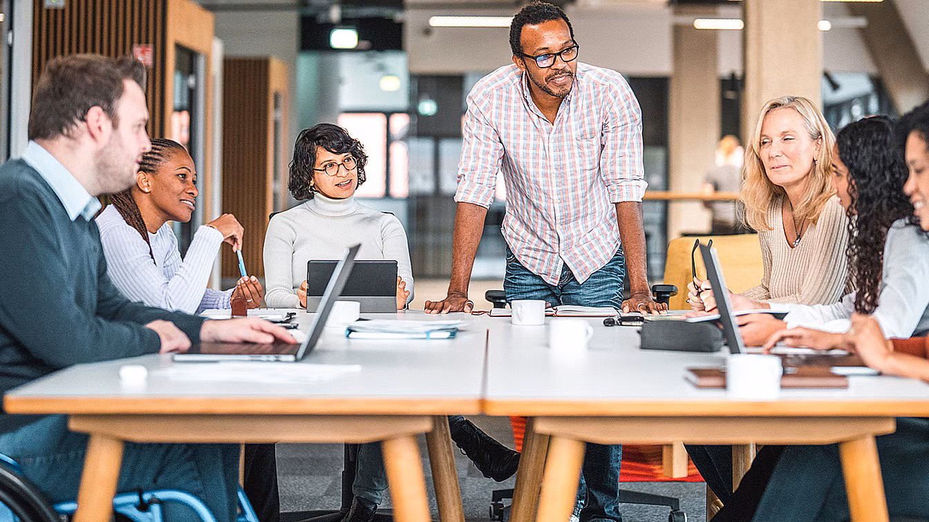 Diverse group of people working at a table.