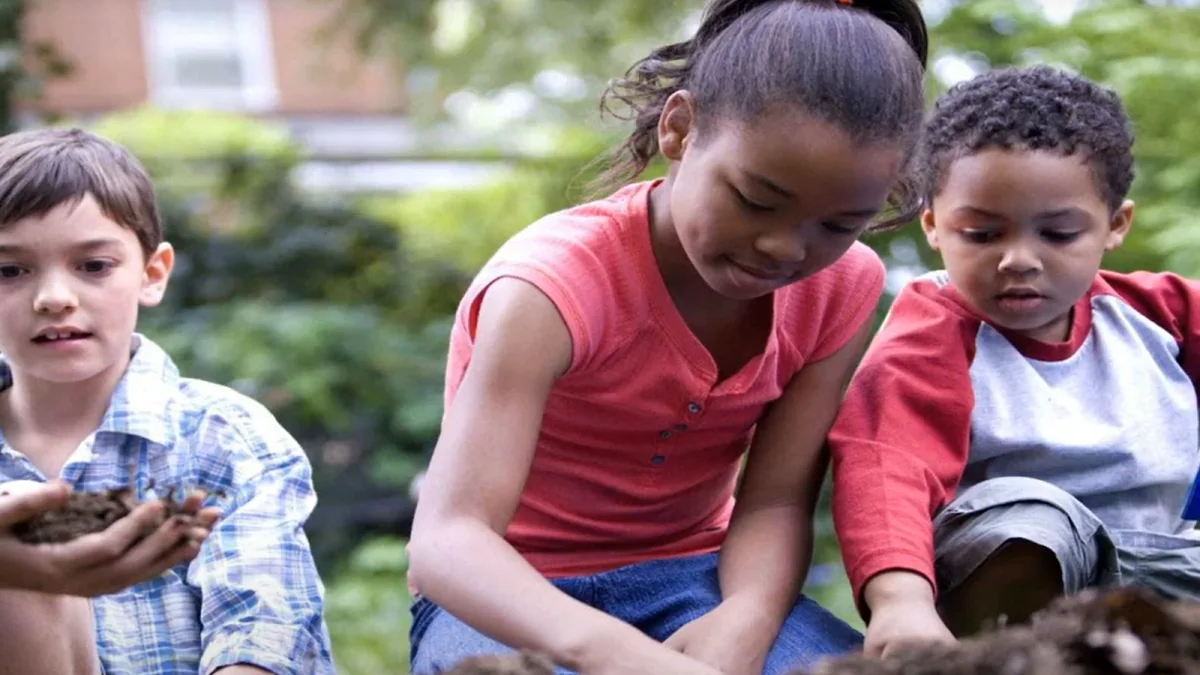 — title missing — Kids are playing with their hands in dirt.