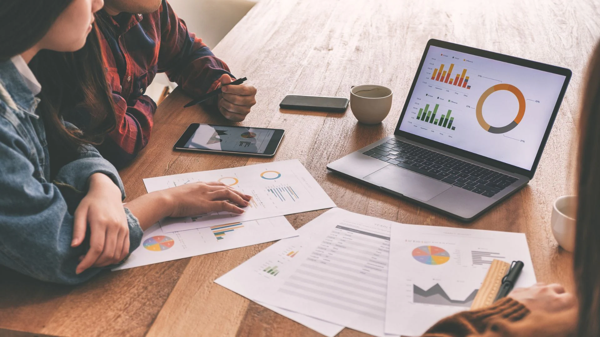 Person looking at Data Two people looking at data on a laptop