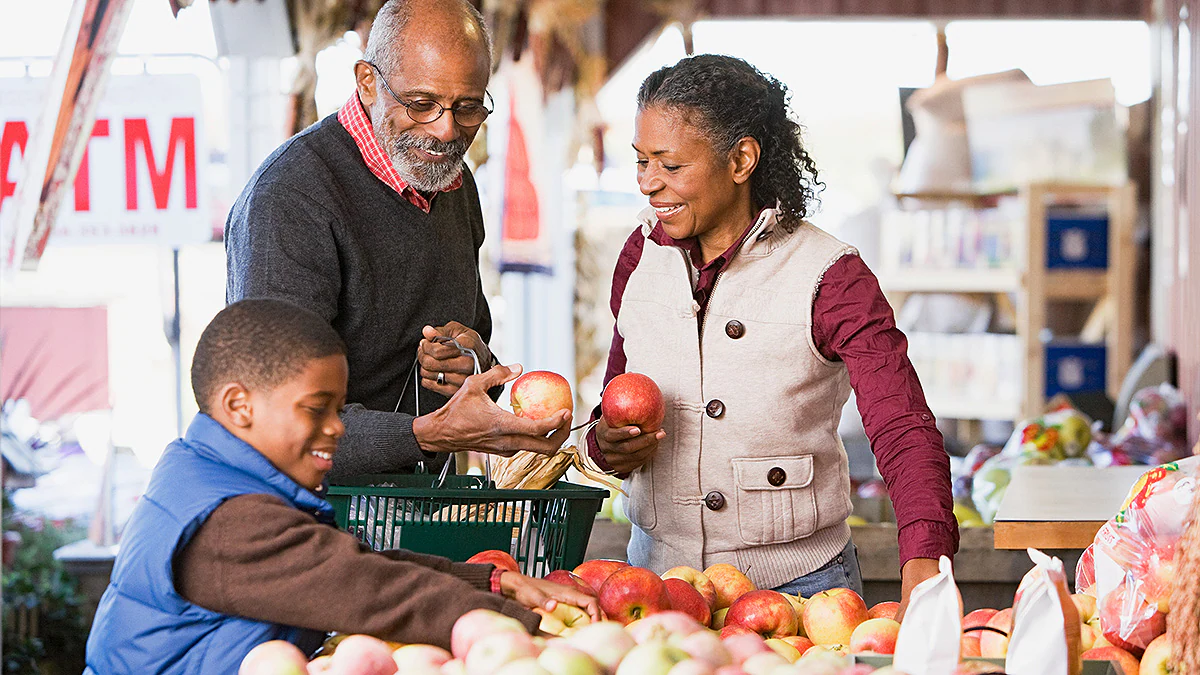 Grandparents Choosing Apples Grandparents and grandson choosing apples at a market.