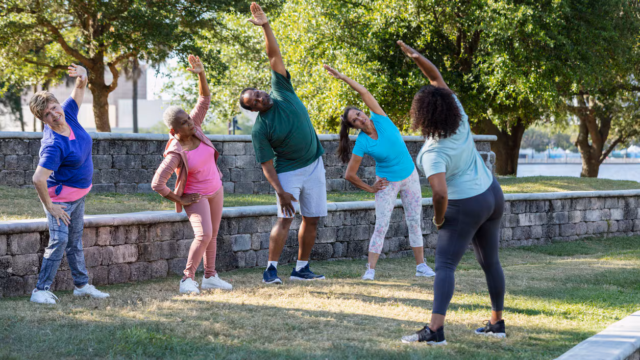 People stretching in the park as a group