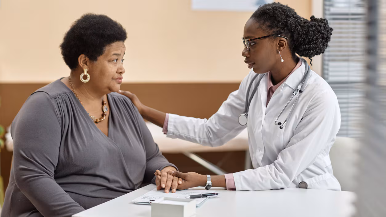 Female Doctor in Hospital Reassuring Patient Woman discusses health concerns with doctor.