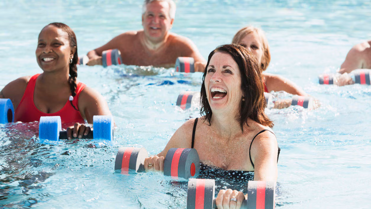 Group of adults enjoying water aerobics.