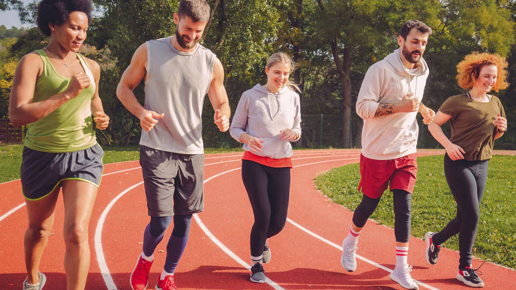 School employee wellness photo Five adults running on a track