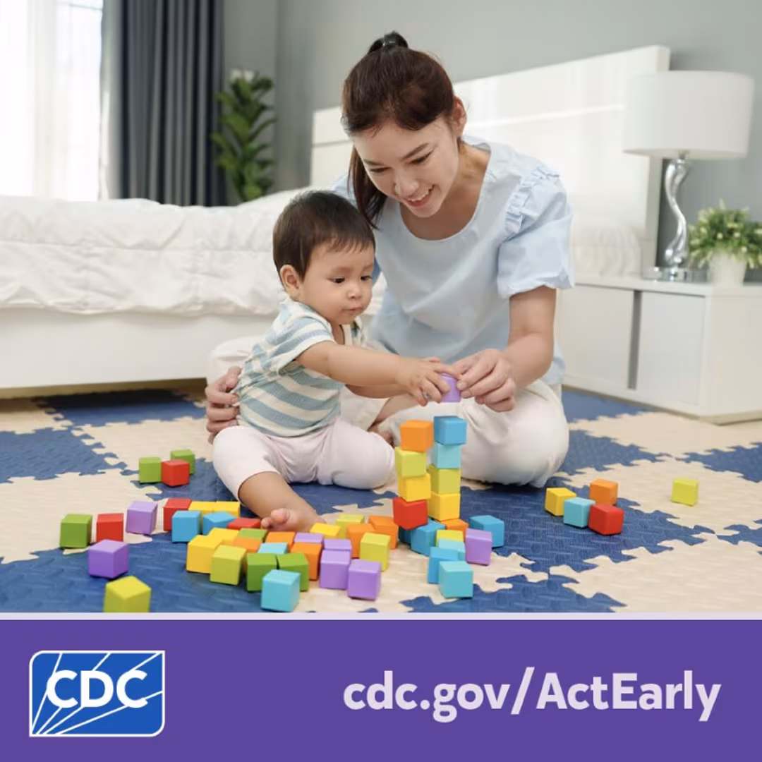 A mother helps her young child play with blocks while sitting on the floor. Text overlay reads, “cdc dot gov slash Act Early.”
