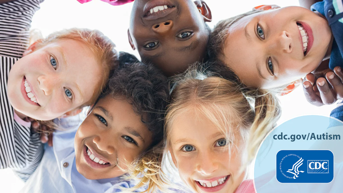 A diverse group of children smiling as they stand closely together in a circle staring downward. Text overlay reads, “cdc dot gov slash Autism.”