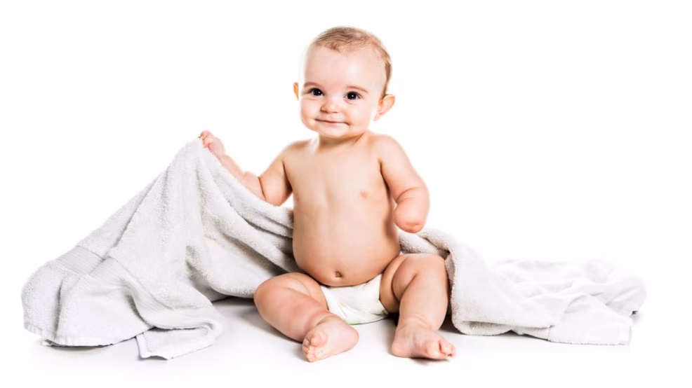 BDbaby.jpg Happy baby with a missing hand from a congenital limb deficiency sitting on a blanket.