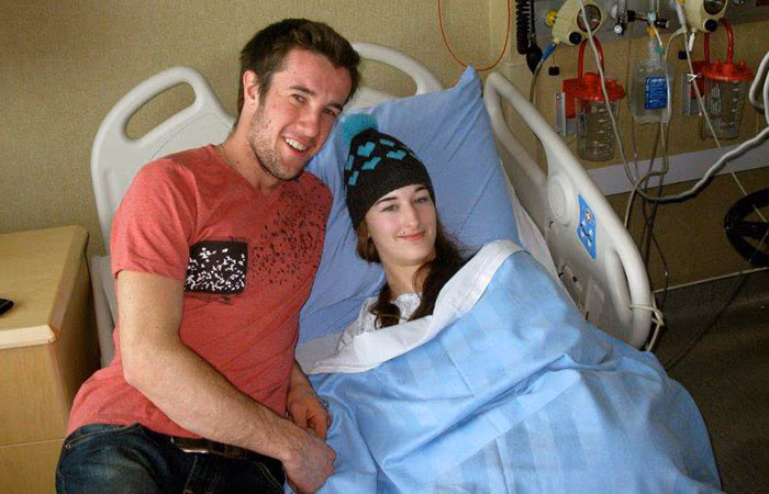 Suzanne Lambregts in a hospital bed with her boyfriend.