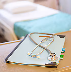 stethoscope.jpg Stethoscope and binder on a table in the hospital room.
