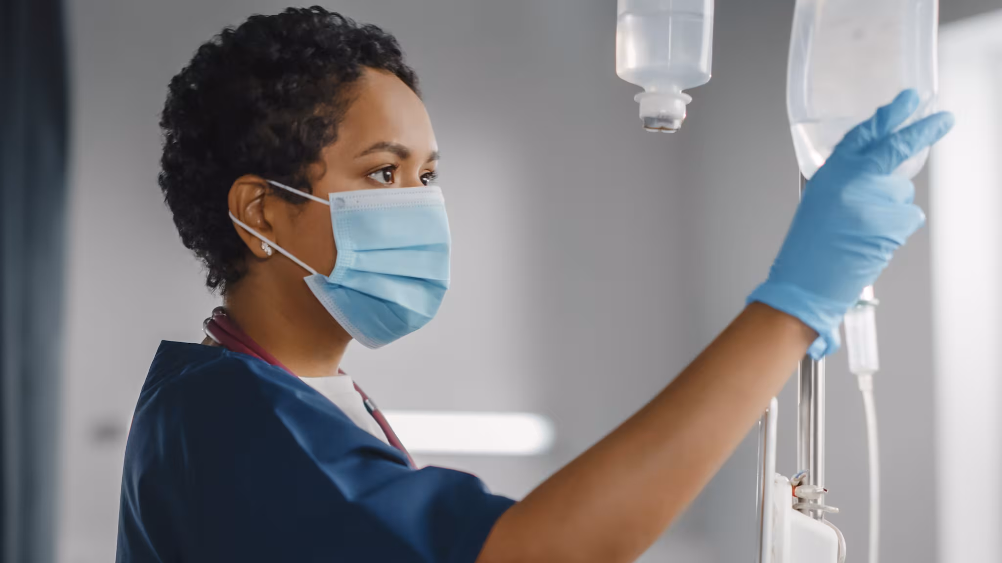 Healthcare provider checks an IV drip