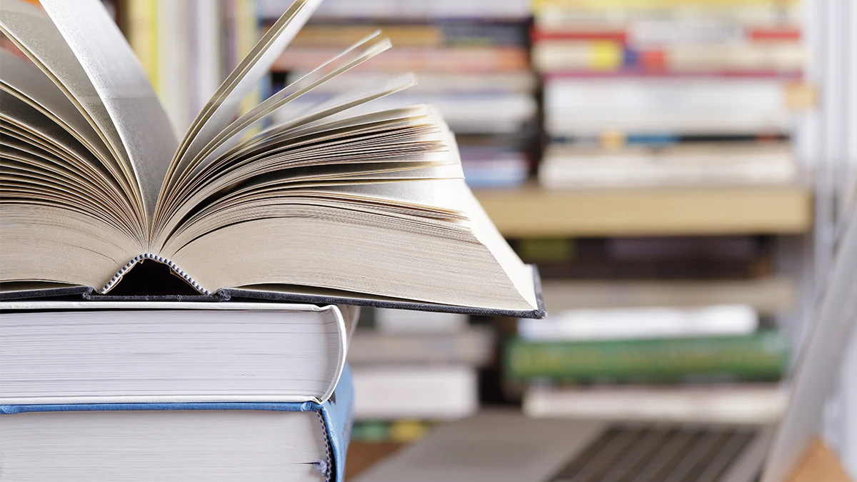 stack of books Stack of books and computer at the library