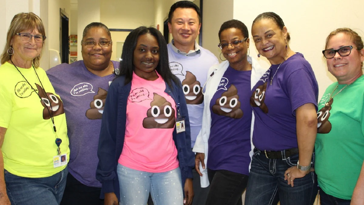 staff at a st. petersburg staff at the St. Petersburg medical home wearing humorous T-shirts to promote colorectal cancer screening with a FIT kit.