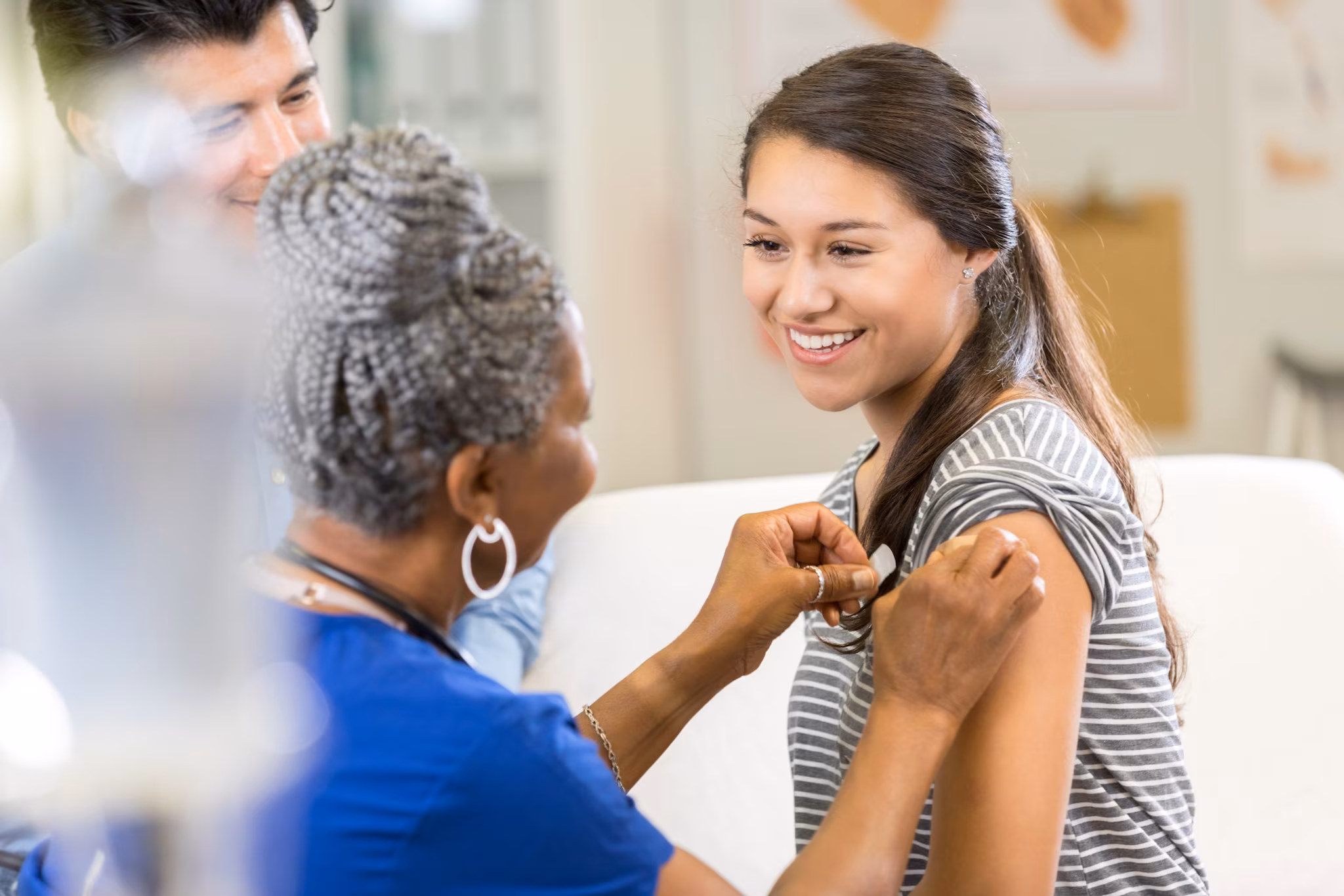 safety efficacy thumbnail Healthcare provider applying a bandage to a pediatric patient's arm as a parent looks on.