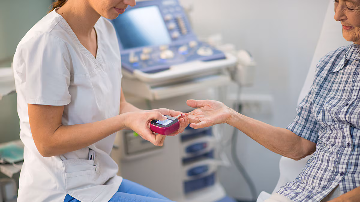 Diabetes Test Nurse giving an elderly patient a diabetes test