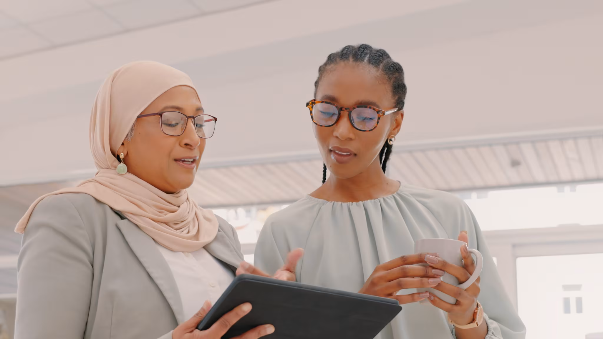 Two women looking at tablet.