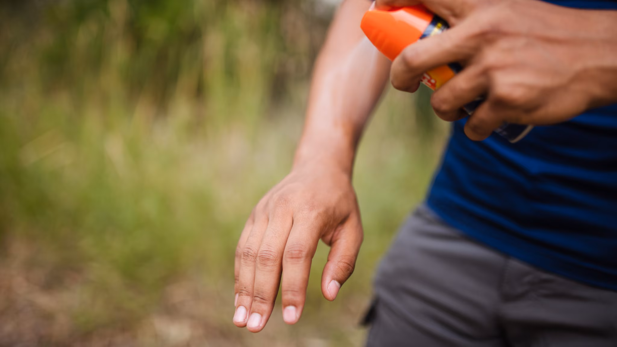 Person applying insect repellent