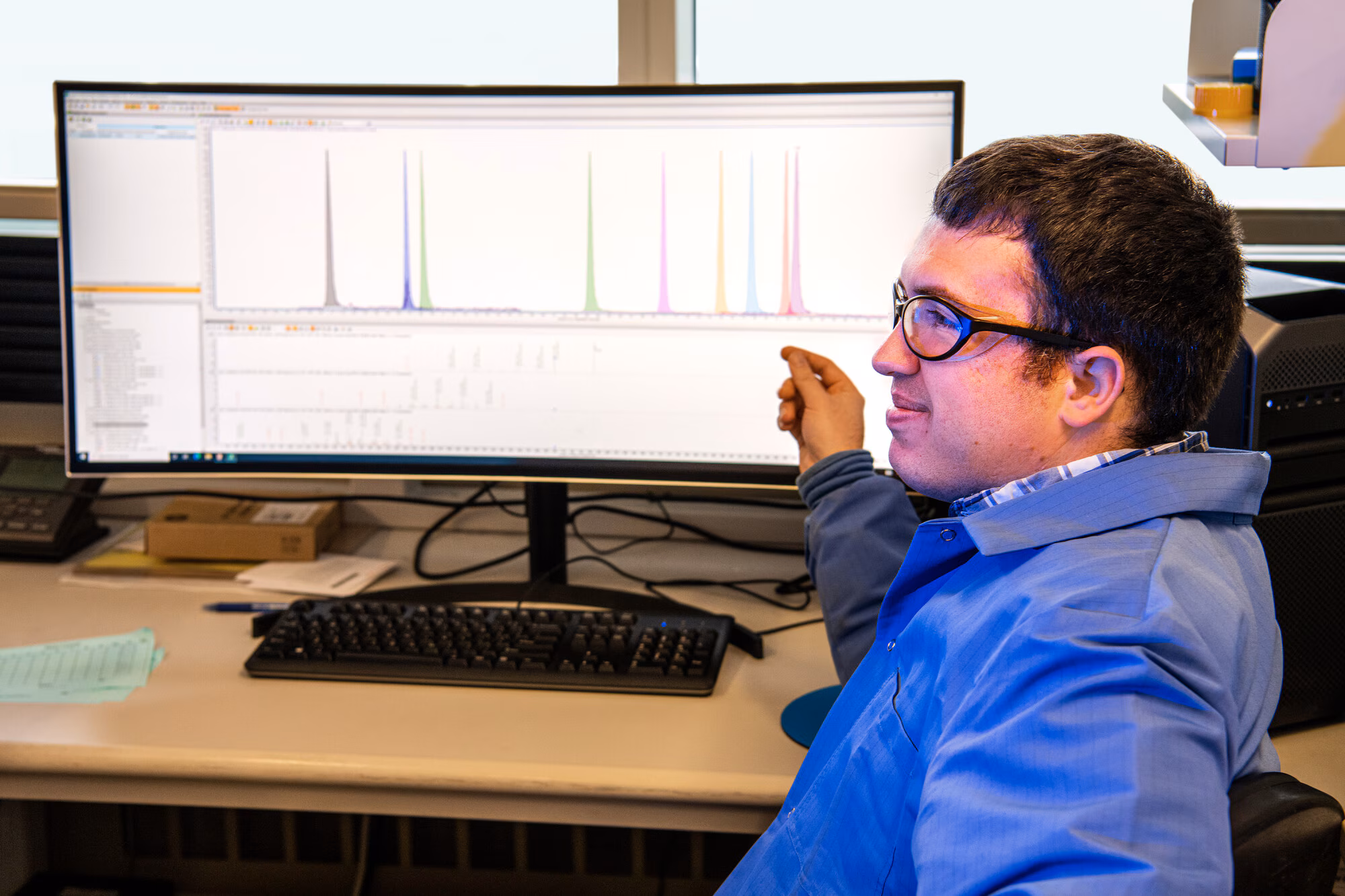 Lab Tech Reviewing Chemicals & Data