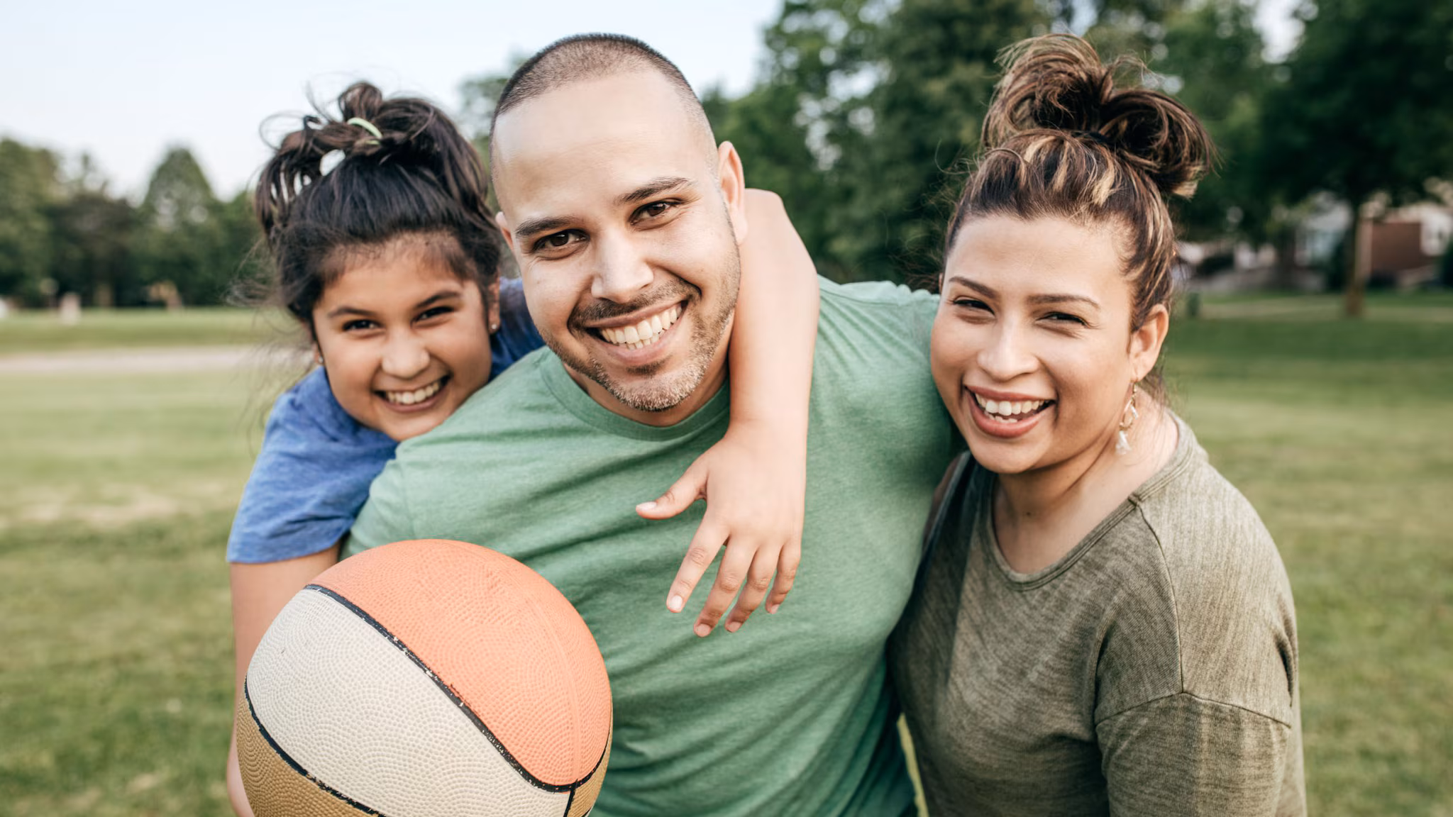 Family playing basketball outside