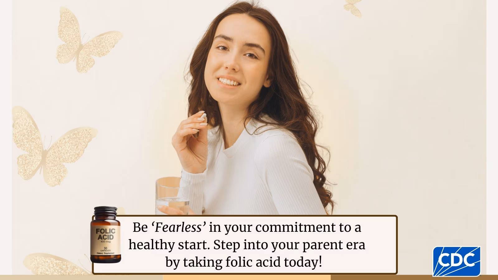 Be 'Fearless' in your commitment to a healthy start- X A young adult holding a folic acid vitamin while looking at the camera, butterflies are seen in the background.