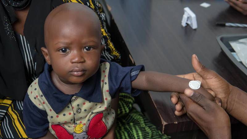 Microneedle A young boy receives the measles microneedle patch vaccine.