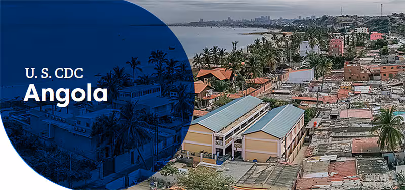 Aerial view of coastal Angola featuring urban areas with palm trees and distant city skyline.