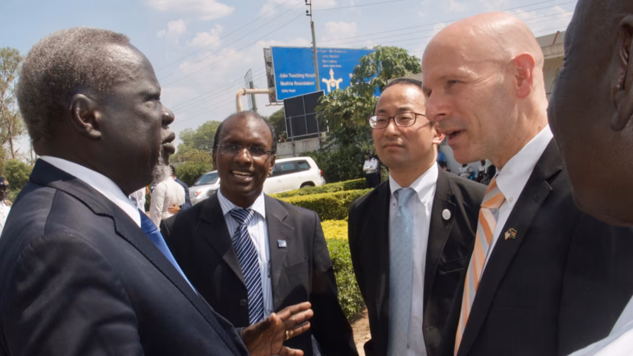 SouthSudan_Juba-Lab-Inauguration_Photo_2018 Four people are wearing suits and standing outdoors while talking