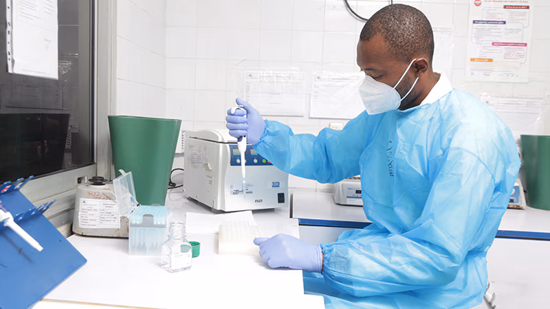 A man preparing the COVID-19 test kits in the lab