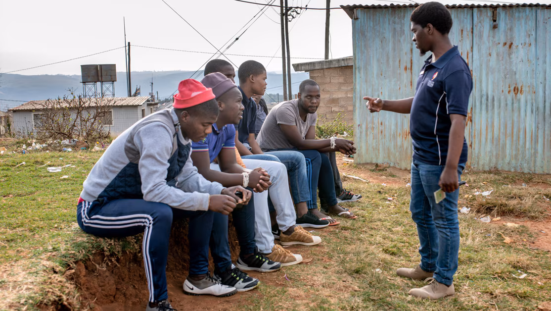 Counselor speaking to a group of young men
