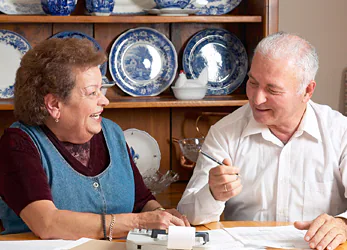 Elderly couple reviewing documents.