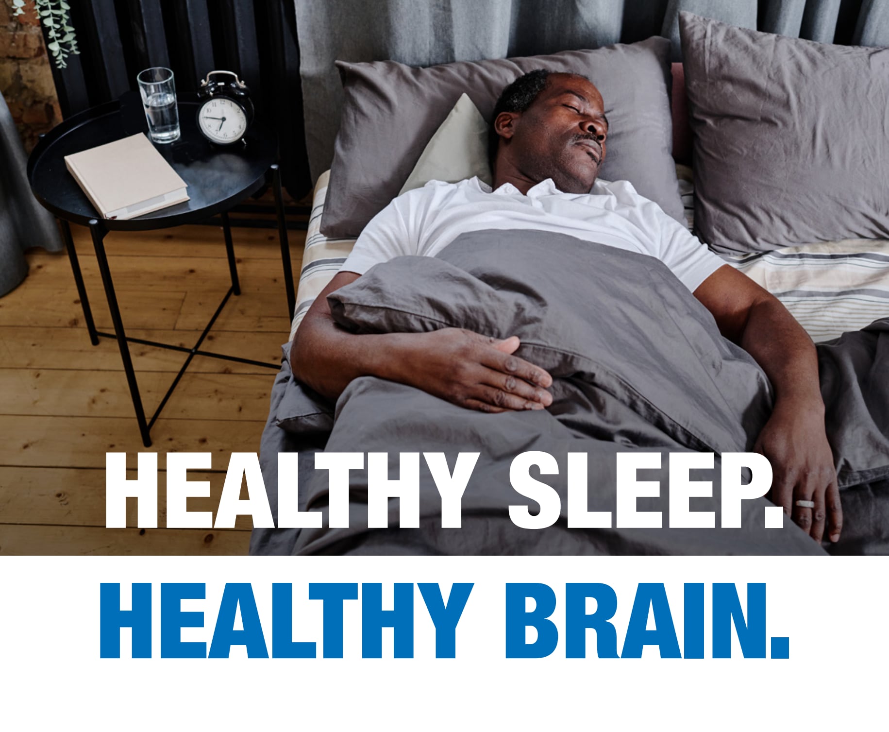 Healthy Sleep. Healthy Brain. African-American man sleeping peacefully in bed. Text: Healthy Sleep. Healthy Brain.