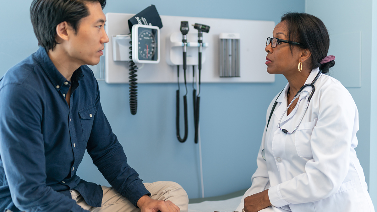Hepatitis B Clinical Care and Treatment Thumbnail A patient sitting on an exam table speaking with a healthcare professional