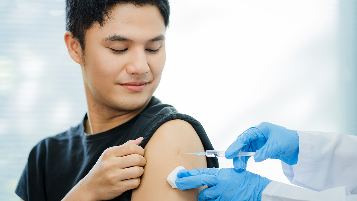 Hepatitis B Prevention and Control Thumbnail A doctor administering a vaccine in a man's shoulder