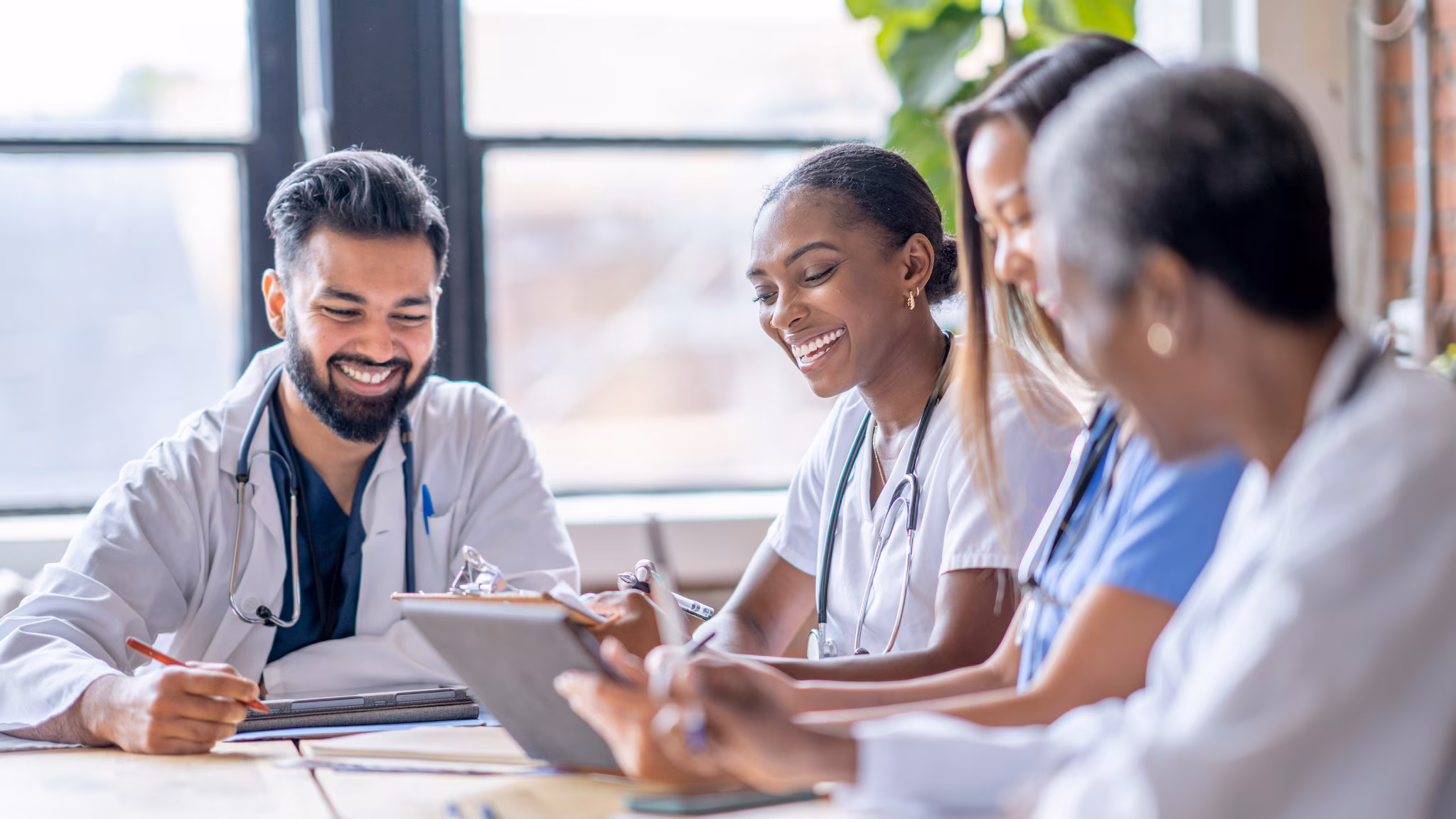 CDR Health Department Guidance thumbnail Group of medical providers seated at a table, talking and smiling.