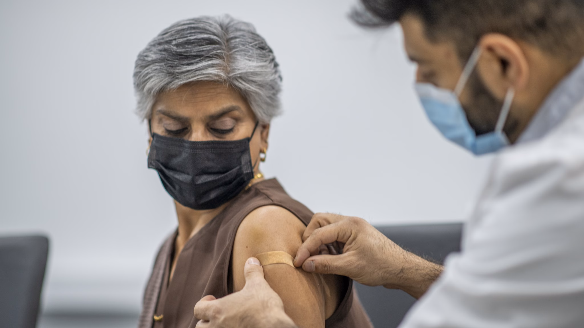 Adult woman receiving vaccine in arm