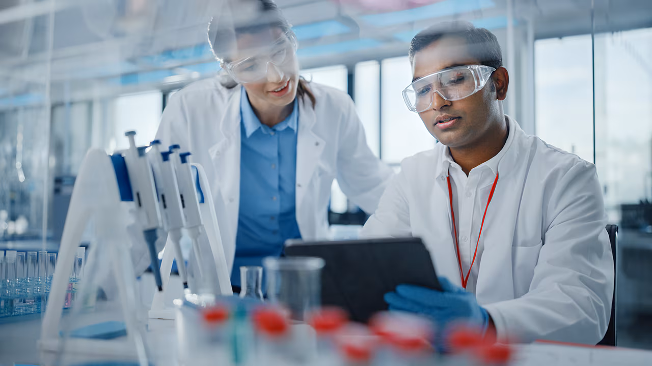 Laboratory professionals reviewing specimen collection guidance.