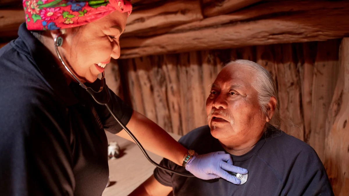 Nurse Patient A nurse checking a patient's heart beat