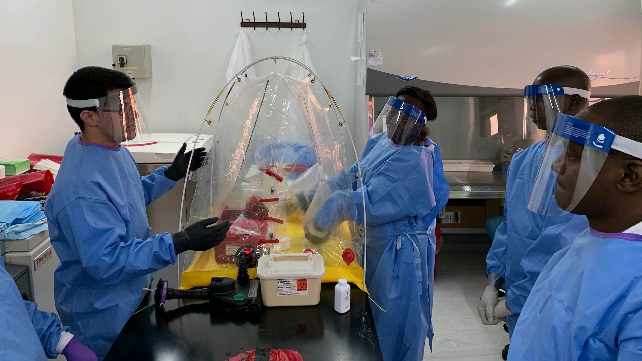 how-fellows-serve-1 An LLS fellow (left) trains laboratory partners on infectious disease testing assays and how to remain safe with protective personal equipment.