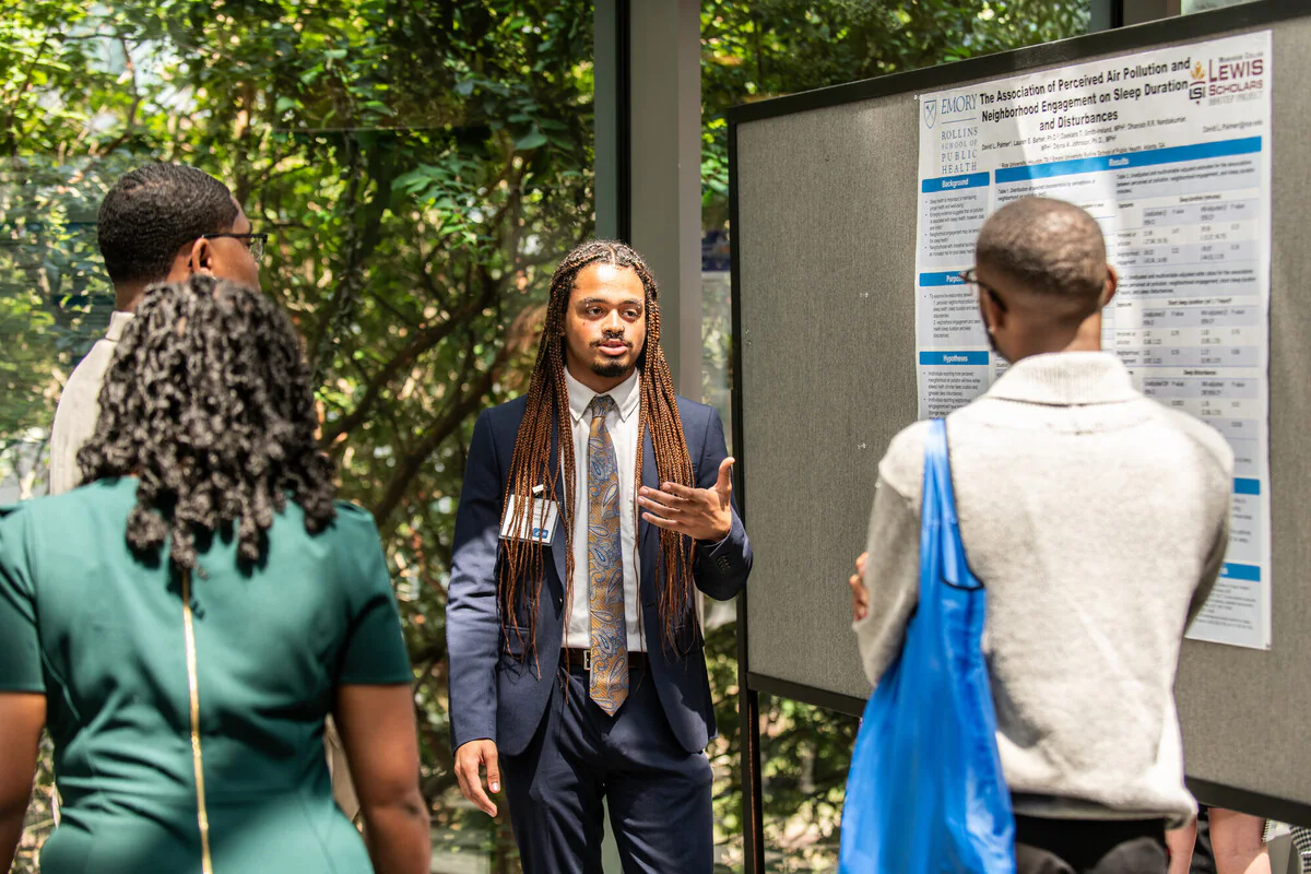 Student shares research project with program participants.