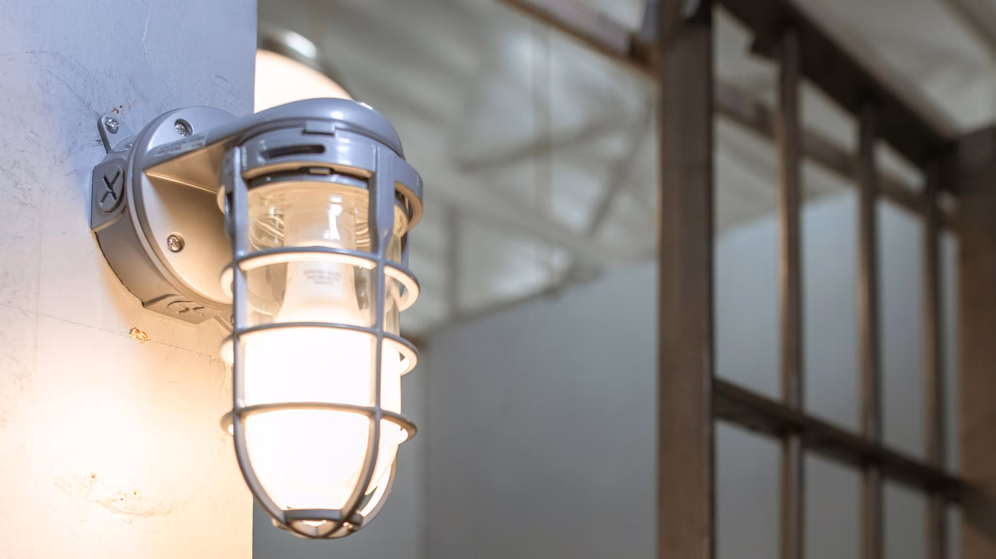 Lamp lit next to correctional cell.