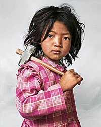 nepal-child.jpg Photograph of a Nepalese child holding a hammer