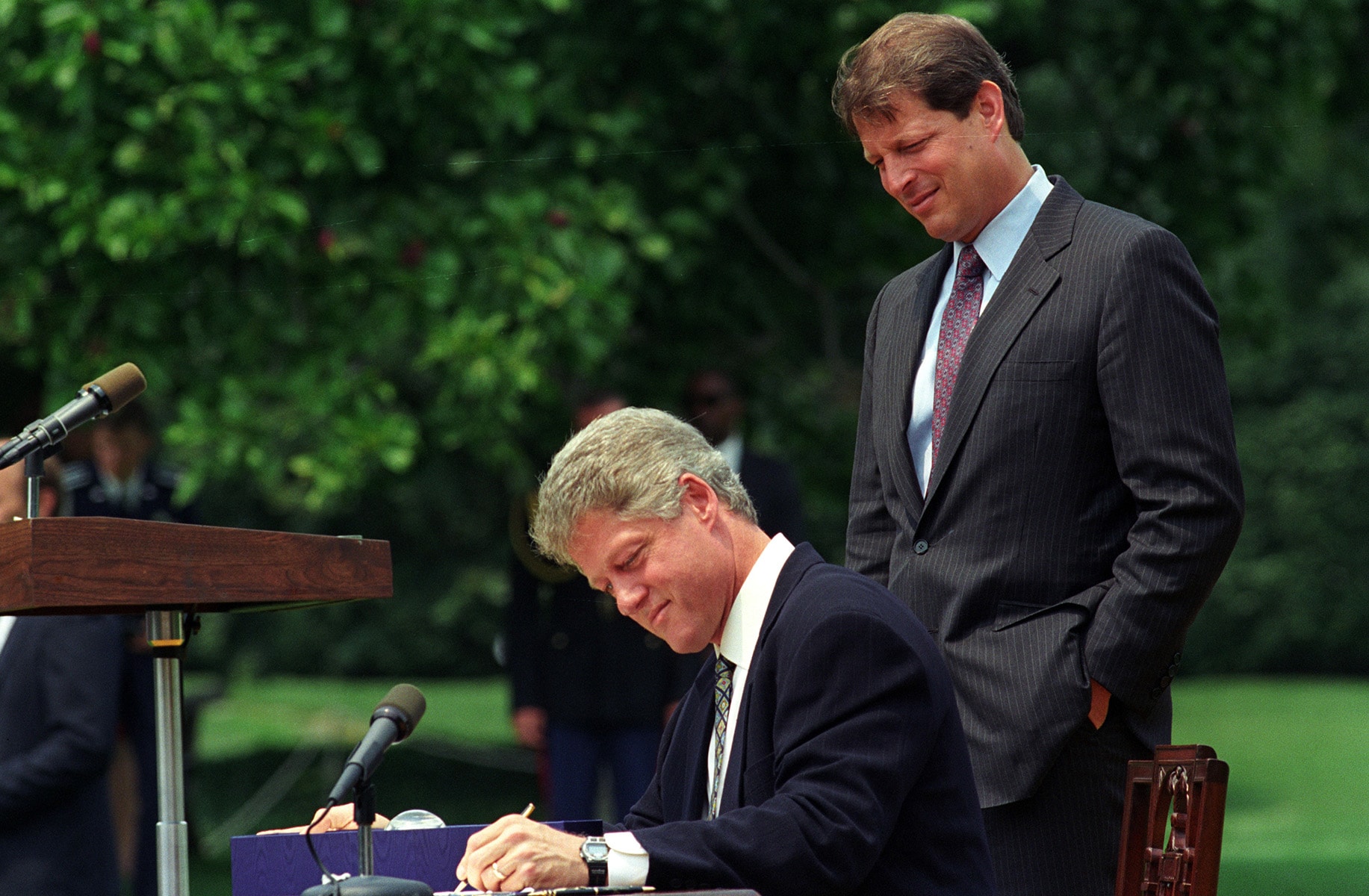 P06383_15_10AUG1993_H President Bill Clinton (seated) and Vice President Al Gore sign the CII Act in 1993.