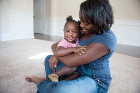 A mom snuggling baby girl-400px-266px A mom snuggling baby girl