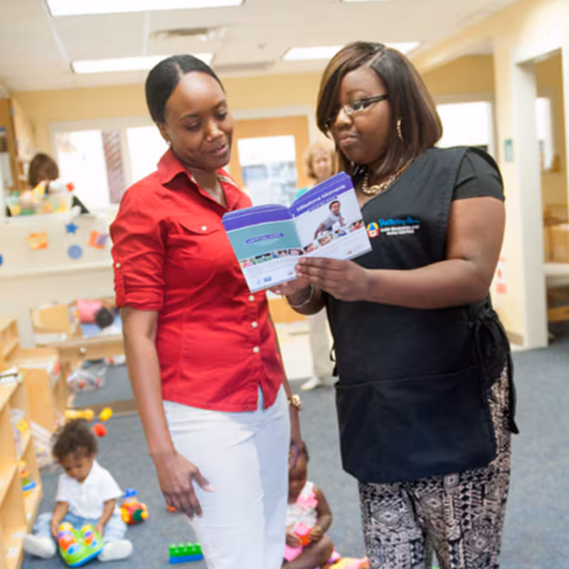 Two women standing in daycare