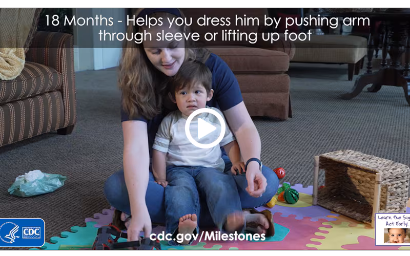 Helps you dress him by pushing arm through sleeve or lifting up foot