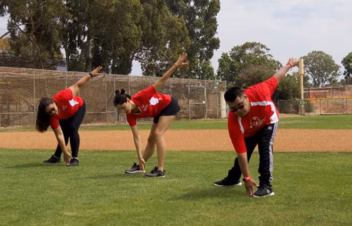 Athletes stretching on a baseball field
