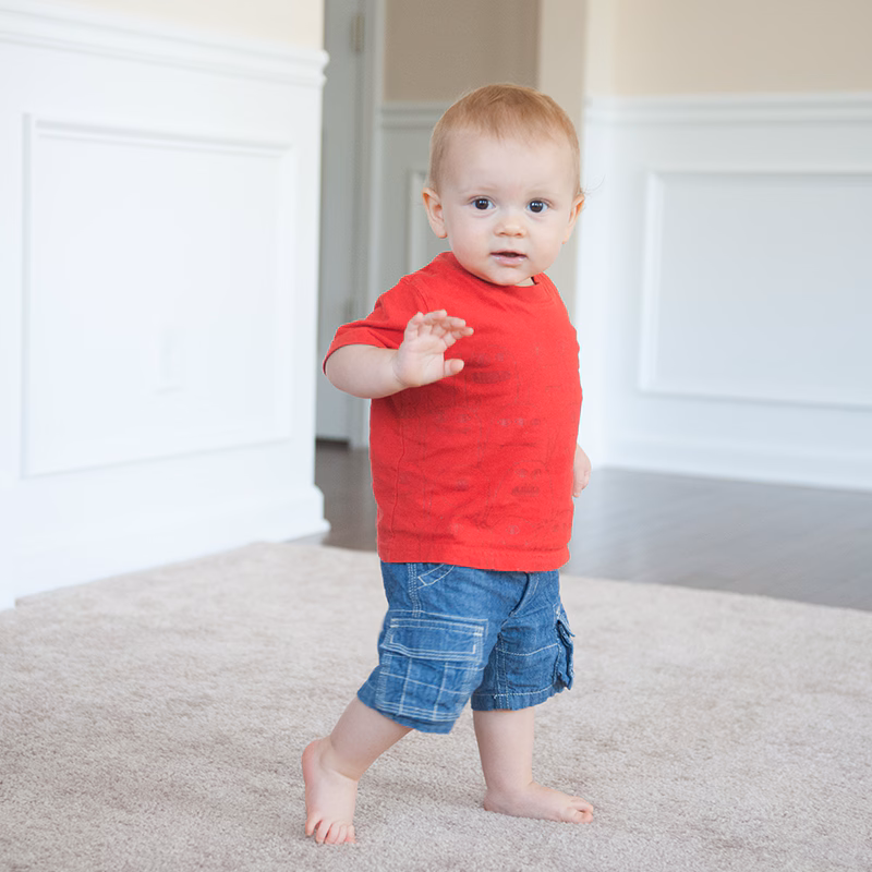 A boy takes a few steps on his own