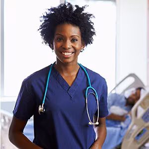 nurse Nurse standing in patient room with patient in the background.