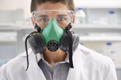 lab-tech-with-mask-on Lab worker wearing a respirator.