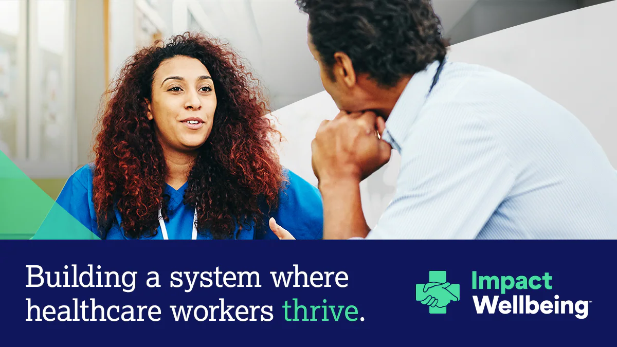 Impact Wellbeing Landing Page Hero Healthcare worker speaking to an executive with text "Building a system where healthcare workers thrive."